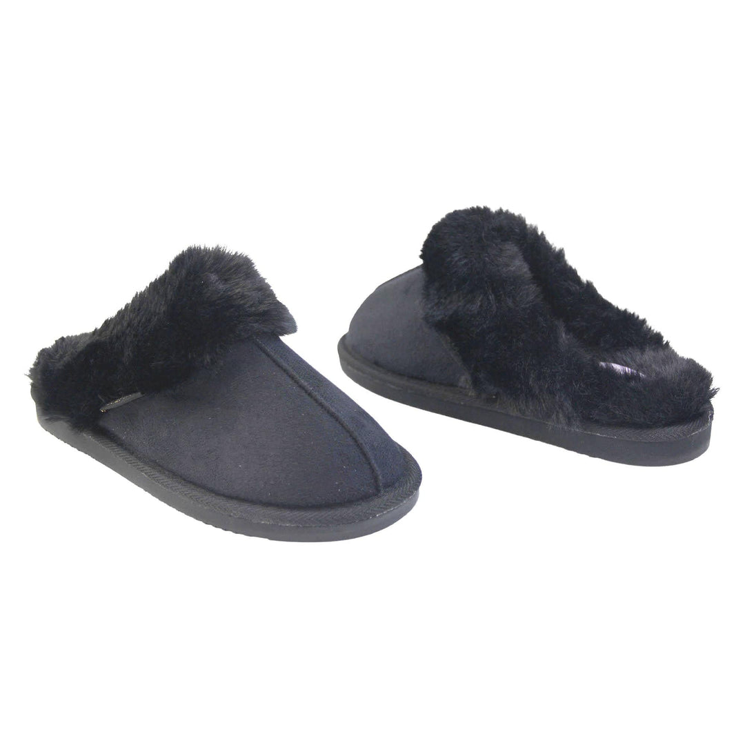 Ladies Memory Foam Slippers. Mule style slippers with black faux suede uppers. Black faux fur lining and collar. Firm black outsole with grip on the bottom. Both feet at an angle, facing top to tail.