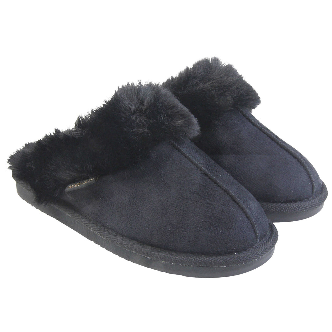 Ladies Memory Foam Slippers. Mule style slippers with black faux suede uppers. Black faux fur lining and collar. Firm black outsole with grip on the bottom. Both feet together at an angle.