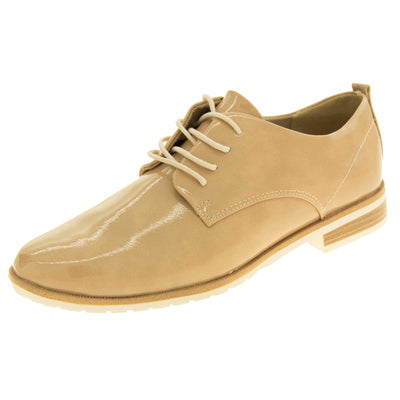 Ladies oxfords. Womens oxford style shoes with a beige patent faux leather upper. Stitching detail to the sides. Cream laces and beige lining. Brown and cream sole with a very slight heel. Left foot at an angle.