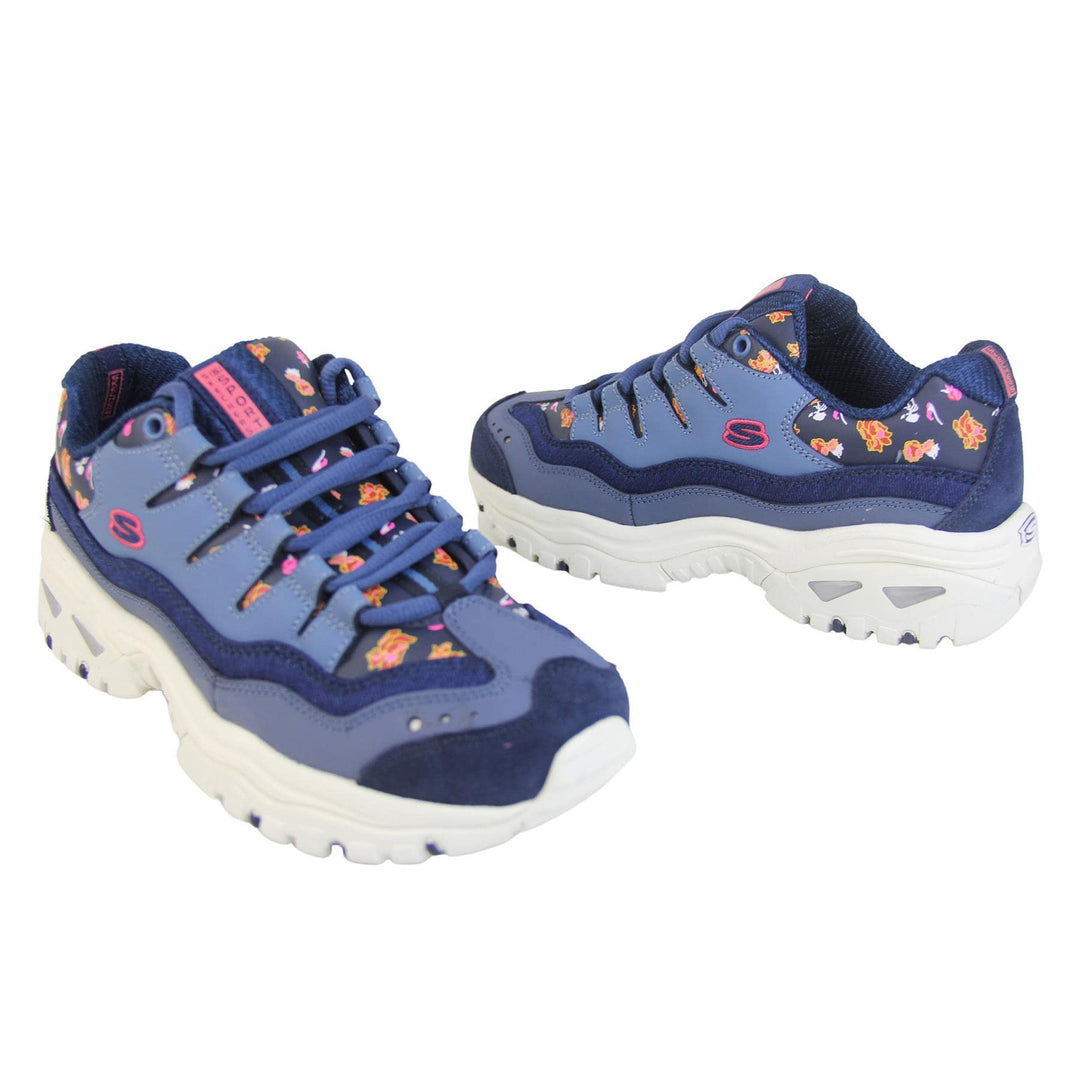 Blue Sketchers trainers with denim edging and a floral print. Lace up fastening with thick white soles. Both outside view