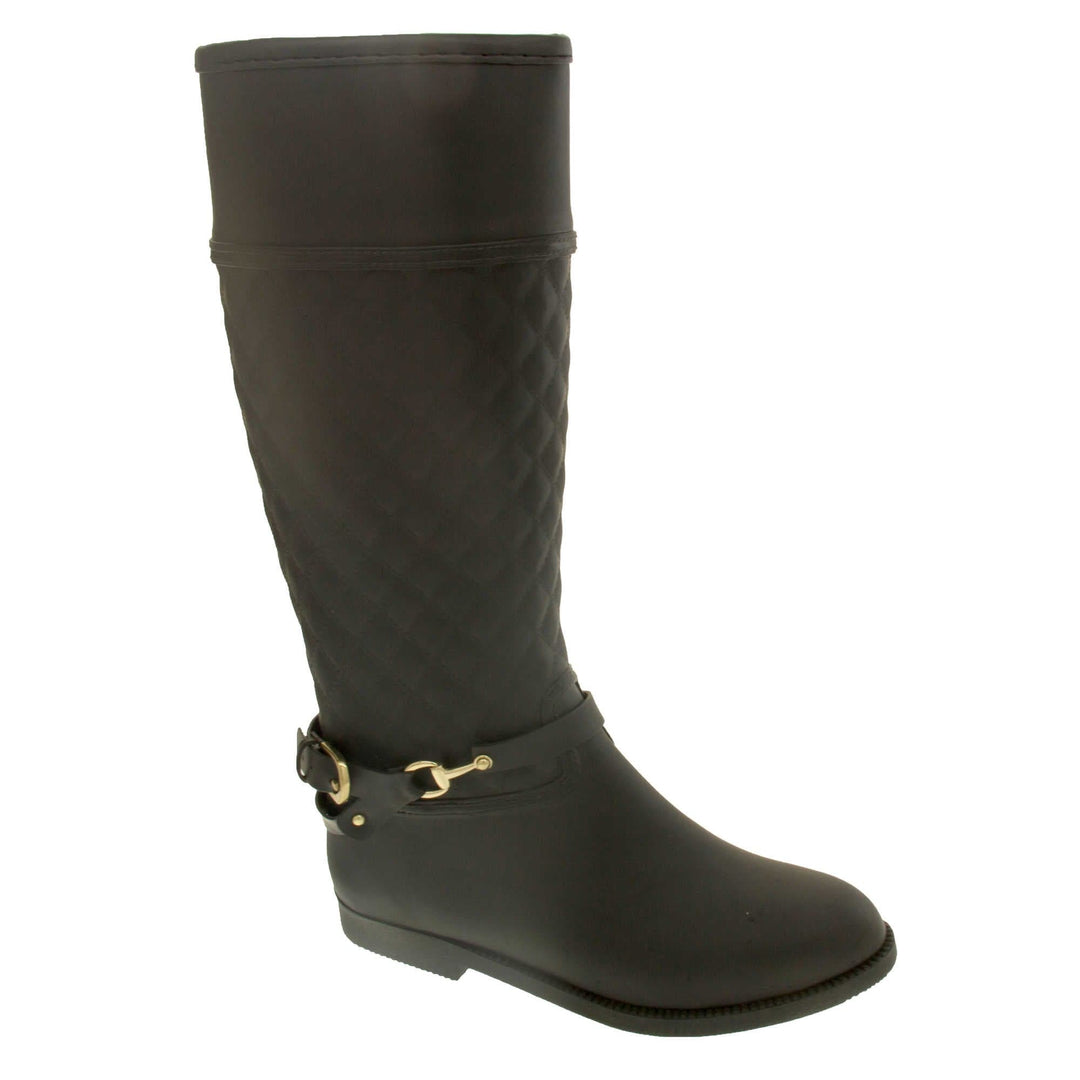 ladies wellies. Women's wellington boots in a knee length style. Black rubber upper with the leg done in a quilted effect. black rubber strap with buckle detail around the ankle. Black non slip sole. Right foot at an angle.