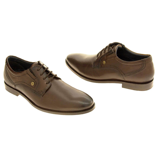 Leather dress shoes. Mens formal shoes with a brown leather upper and stitching detail. Brown laces to the front. Small gold stud on the side with S Oliver written on. Brown sole with very slight heel. Brown lining. Both feet at an angle about an inch apart facing top to tail.