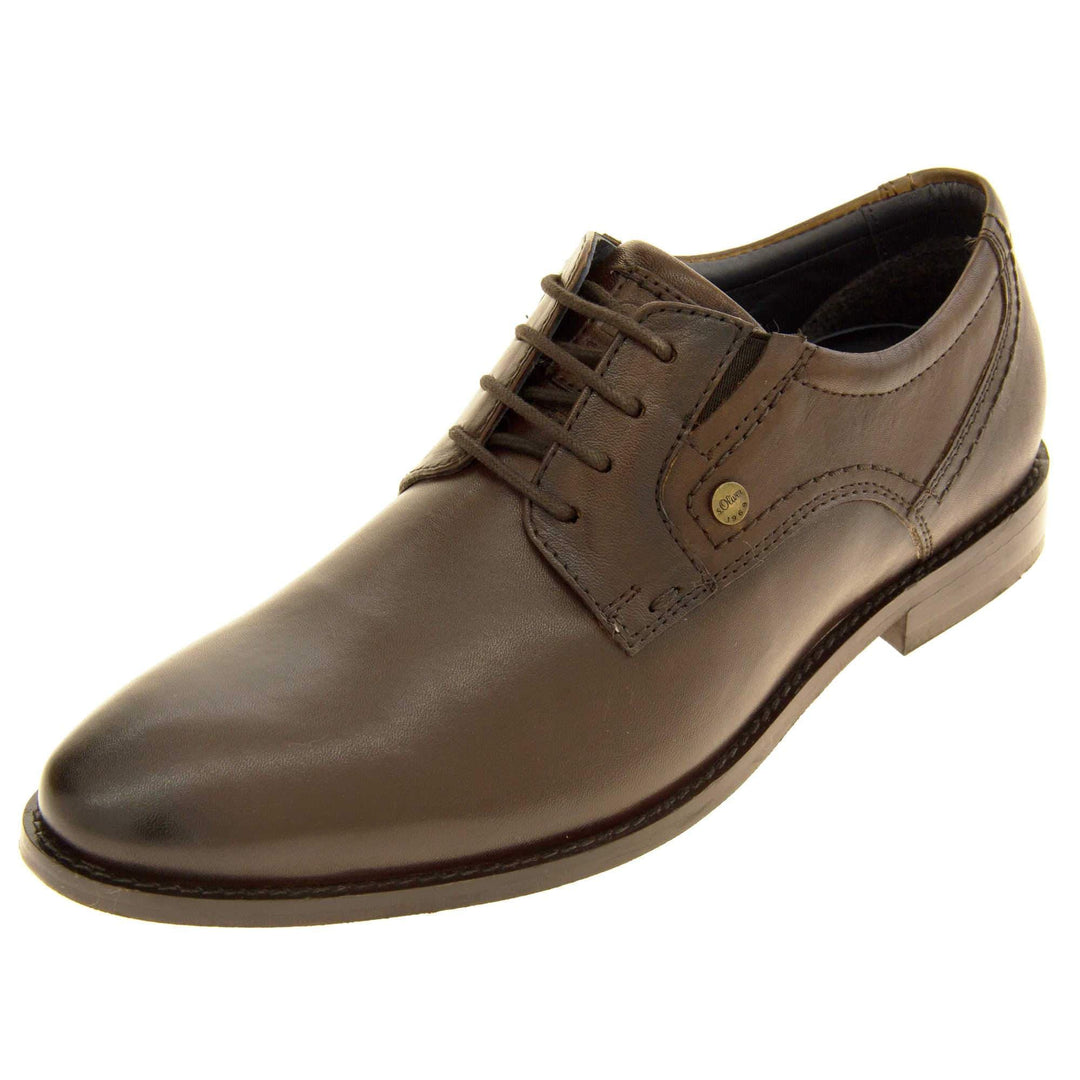 Leather dress shoes. Mens formal shoes with a brown leather upper and stitching detail. Brown laces to the front. Small gold stud on the side with S Oliver written on. Brown sole with very slight heel. Brown lining. Left foot at an angle.
