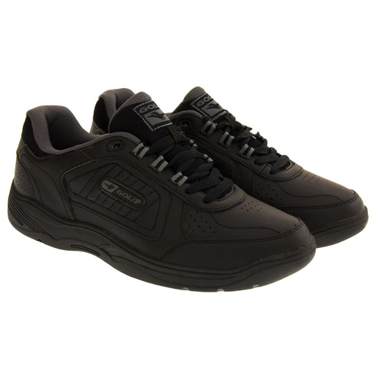 Leather trainers mens. Classic trainer style with black leather upper and black stitching detail. Black laces and tongue with black textile lining. Black and grey Gola branding to the side. Black outsole. Both feet together from an angle.