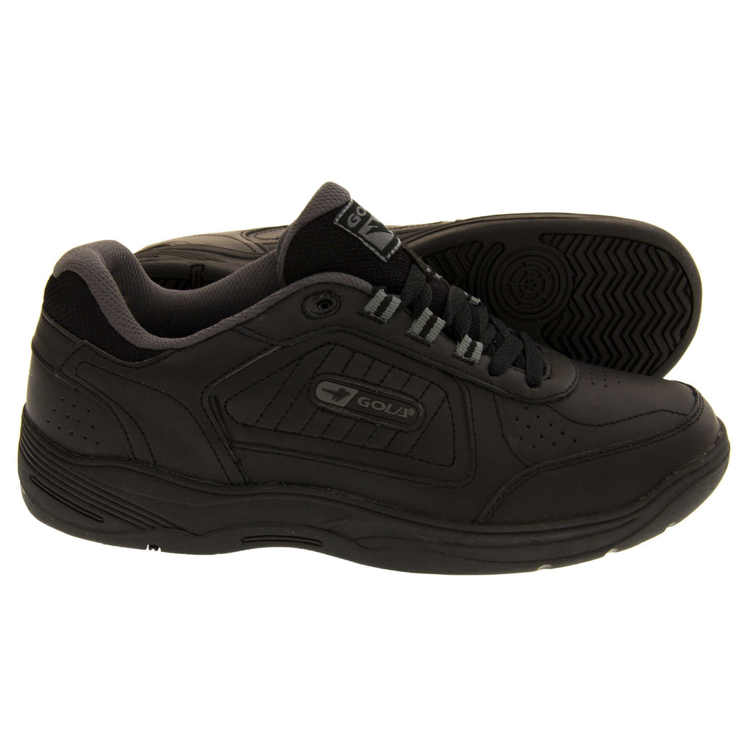 Leather trainers mens. Classic trainer style with black leather upper and black stitching detail. Black laces and tongue with black textile lining. Black and grey Gola branding to the side. Black outsole. Both feet from a side profile with the left foot on its side to show the sole.