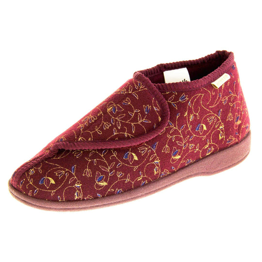 Machine washable slippers. Womens bootie style slipper with a burgundy textile upper with vine and flower embroidered design. Touch fasten tab to the top and red textile lining. Firm red sole. Left foot at an angle.