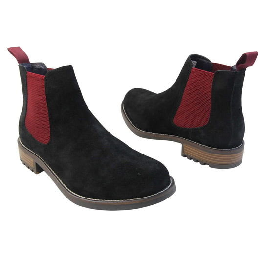 Mens black Chelsea boots. Ankle boots with black suede leather uppers and red textile elasticated side panels. Red textile tab to the back rim to help pull shoes on. Embossed Oakenwood brand to the outside heel of the boot. Black sole with very slight heel. Both feet at an angle facing top to tail.