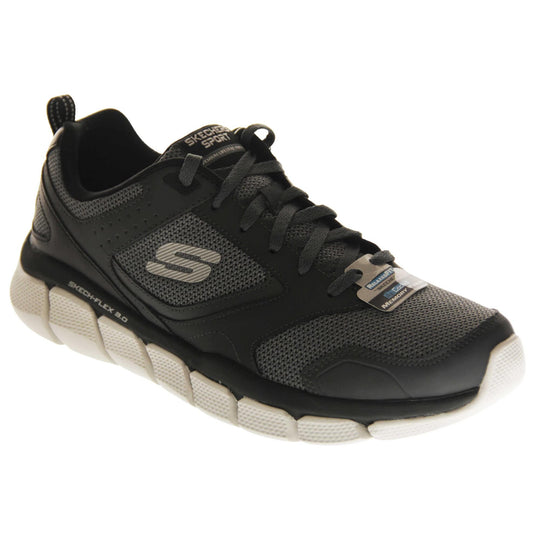 Mens black Skechers. Dark grey mesh and black leather upper with black laces and black lining. Grey Skechers logo to the side and chunky white outsole with grip. Right foot at an angle