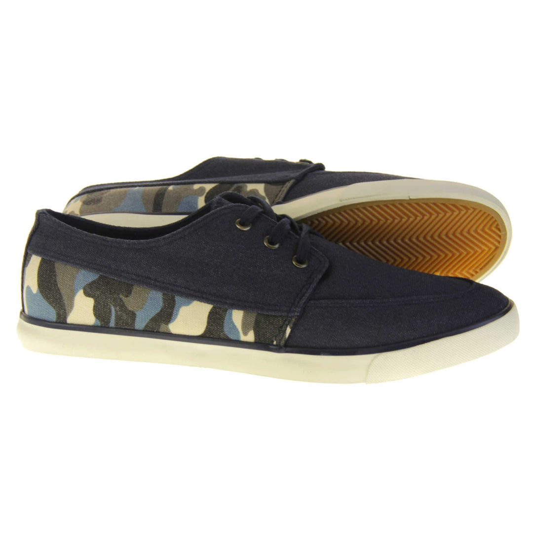 Mens camouflage pumps. Navy blue canvas upper with blue camo strip around the heel. Navy laces. White synthetic sole and dark textile lining. Both feet from a side profile with left foot behind the right on its side to show the sole.