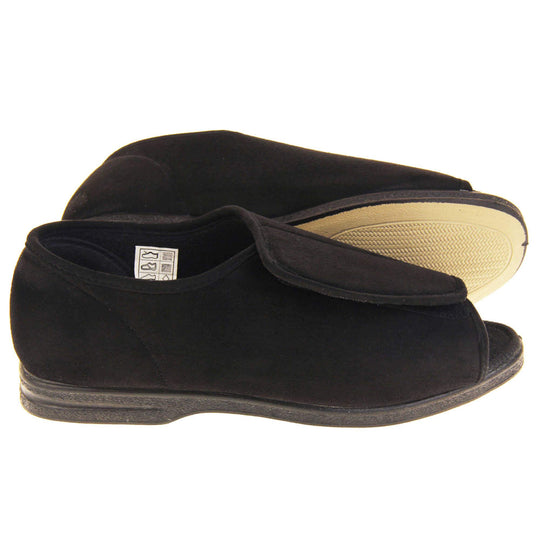 Mens Extra Wide Open Toe Slippers. Full back slippers with black textile upper. Open toe and the top of the shoe is an adjustable touch fasten strap. Black textile lining. Firm black sole. Both feet from side profile with left foot on its side to show the sole.