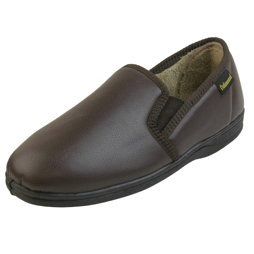 Mens faux leather slippers. Brown faux leather classic full back slipper with beige fleece lining. Left foot from an angle.
