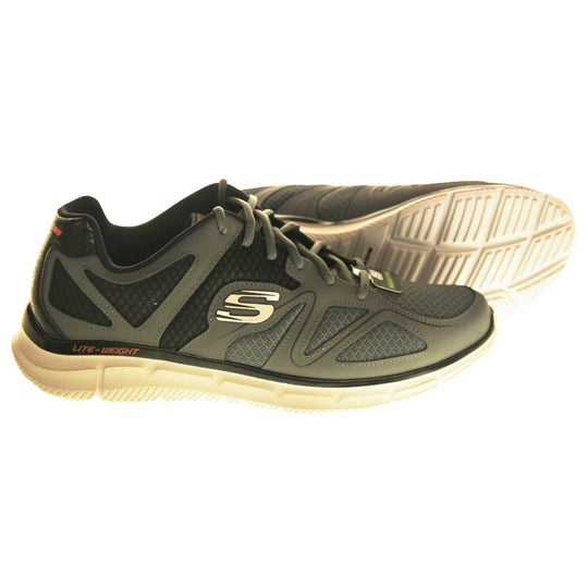 Mens grey Skechers. Charcoal grey mesh and leather upper with black elasticated laces for a slip on trainer. Black Skechers logo to the heel and chunky white outsole with grip. Both feet from a side profile with the left foot on its side to show the sole.