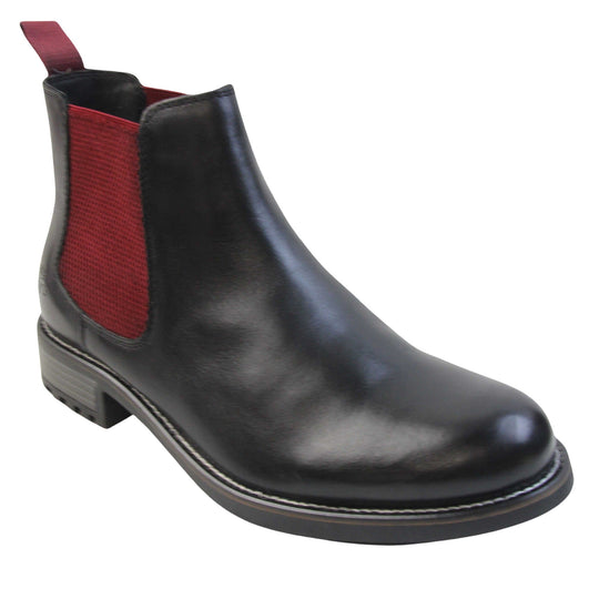 Mens leather Chelsea boots black. Ankle boots with black leather uppers and red textile elasticated side panels. Red textile tab to the back rim to help pull shoes on. Embossed Oakenwood brand to the outside heel of the boot. Black sole with very slight heel. Right foot at an angle.