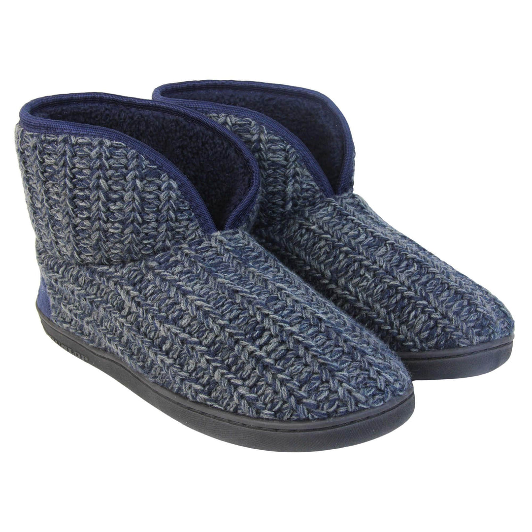 Mens memory foam slippers. Slipper boots with a navy blue knit upper. Navy fabric piping around the collar. Navy textile patch over the heel to reinforce. Thick black synthetic sole with Dunlop branding on. Navy faux fur lining. Both feet together at a slight angle.