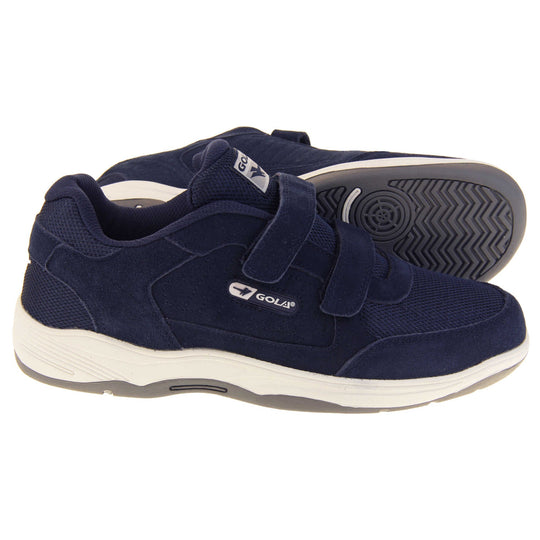 Mens navy trainers. Classic trainer style in wide fit. With navy blue coated leather upper and navy stitching detail. Two navy touch fasten straps with navy tongue and blue textile lining. Black and white Gola branding to the side. Black outsole. Men's grey wide fit trainers. Classic trainer style in wide fit with grey coated leather upper and grey stitching detail. Both feet from a side profile with the left foot on its side to show the sole.