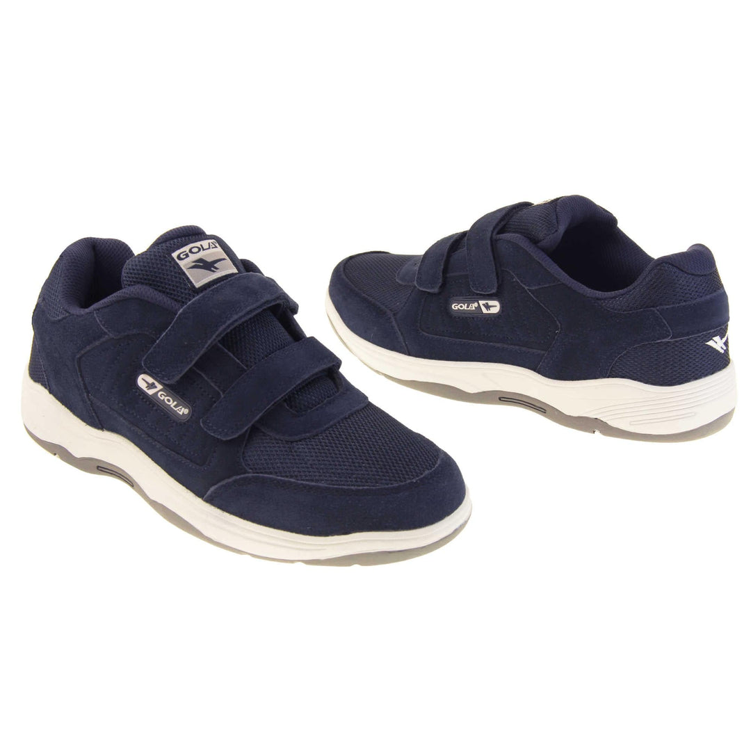 Mens navy trainers. Classic trainer style in wide fit. With navy blue coated leather upper and navy stitching detail. Two navy touch fasten straps with navy tongue and blue textile lining. Black and white Gola branding to the side. Black outsole. Both feet from a slight angle facing top to tail.