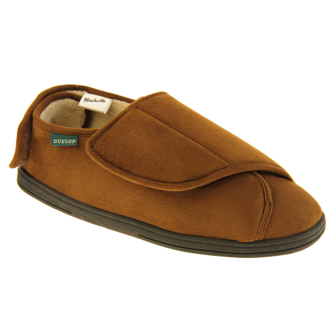 Mens adjustable slippers. Full back slippers with brown upper. Adjustable touch fasten strap to the top of the foot and around the back of the heel. Small white label on the outside rim, with Dunlop branding sewn in black. Cream faux fur lining. Firm black sole. Right foot at an angle.