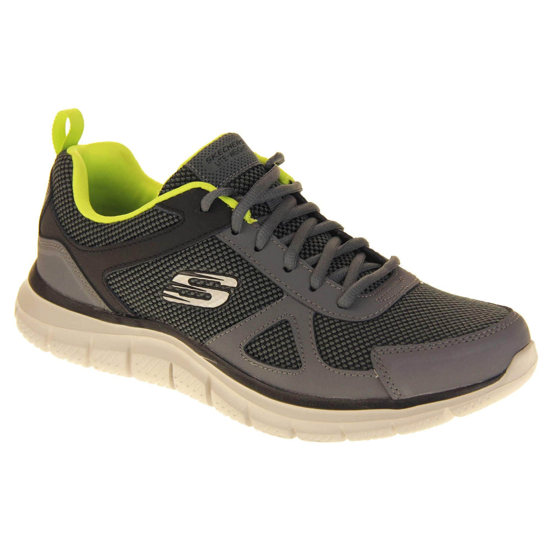 Mens Skechers sports trainers. Charcoal grey mesh and leather upper with grey laces and lime green lining. White Skechers logo to the side and chunky white outsole with black bottom with grip. Right foot at an angle.