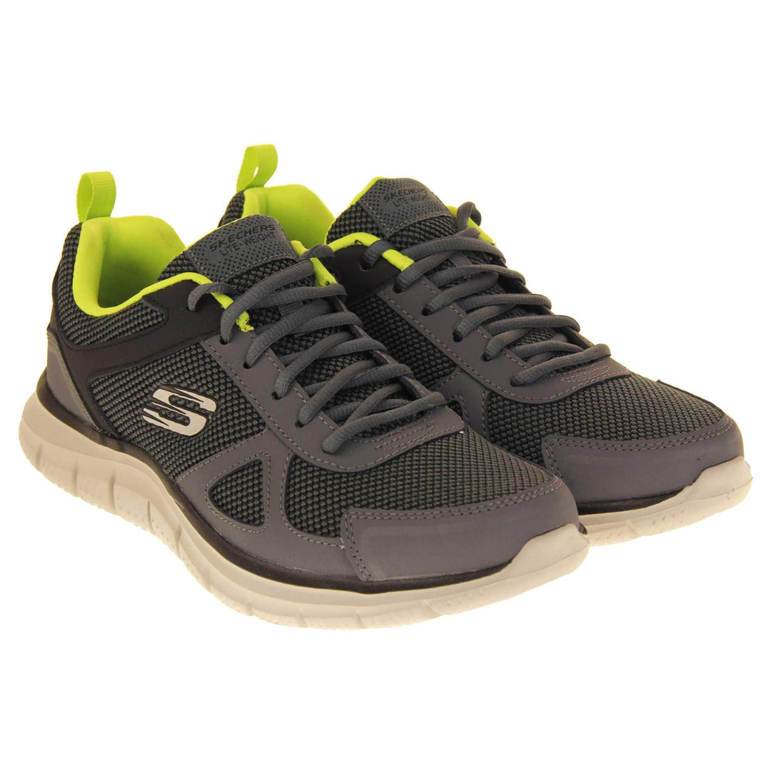 Mens Skechers sports trainers. Charcoal grey mesh and leather upper with grey laces and lime green lining. White Skechers logo to the side and chunky white outsole with black bottom with grip. Both shoes together at an angle.