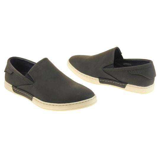 Mens slip on shoes. Black faux leather upper. White synthetic sole and dark textile lining. Both feet at a slight angle facing top to tail.