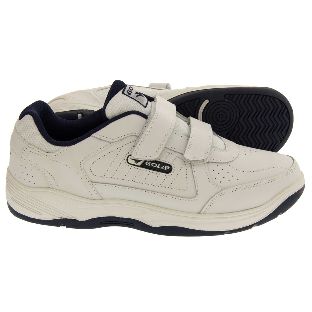 Mens touch fasten trainers. Classic trainer style with white leather upper and white stitching detail. Two white touch fasten straps with white tongue and black textile lining. Black and white Gola branding to the side. White outsole with black bottom. Both feet from a side profile with the left foot on its side to show the sole.