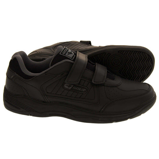 Mens trainers for wide feet. Classic trainer style with black leather upper and black stitching detail. Two black touch fasten straps with black tongue and black textile lining. Black and grey Gola branding to the side. Black outsole. Both feet from a side profile with the left foot on its side to show the sole.
