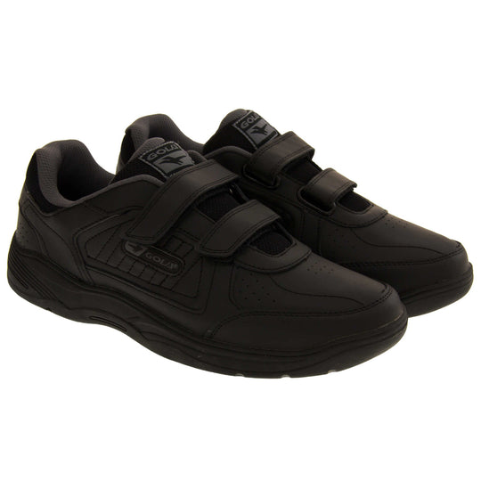 Mens trainers for wide feet. Classic trainer style with black leather upper and black stitching detail. Two black touch fasten straps with black tongue and black textile lining. Black and grey Gola branding to the side. Black outsole. Both feet together from an angle.