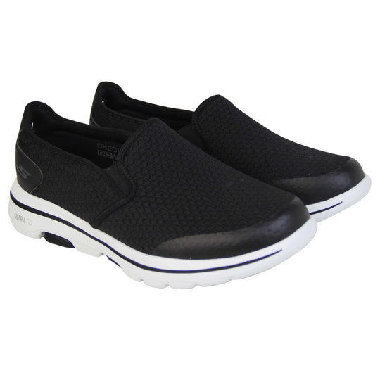 Mens wide fit skechers. Mens loafer style trainers. Black woven mesh upper. Skechers S logo to the back. chunky white sole with a black ling running around the middle and grip to the bottom. Black textile lining. Both feet together from an angle.