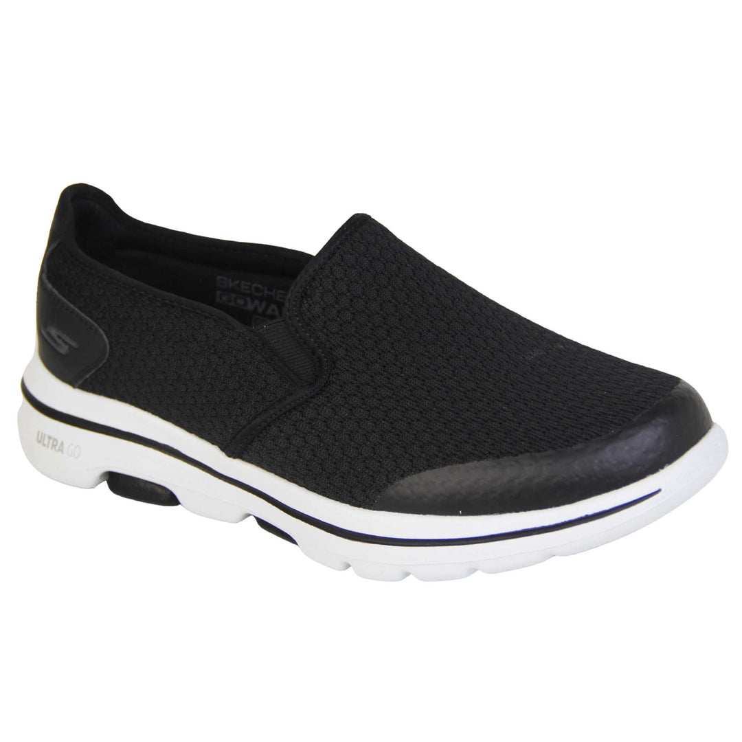 Mens wide fit skechers. Mens loafer style trainers. Black woven mesh upper. Skechers S logo to the back. chunky white sole with a black ling running around the middle and grip to the bottom. Black textile lining. Right foot at an angle.