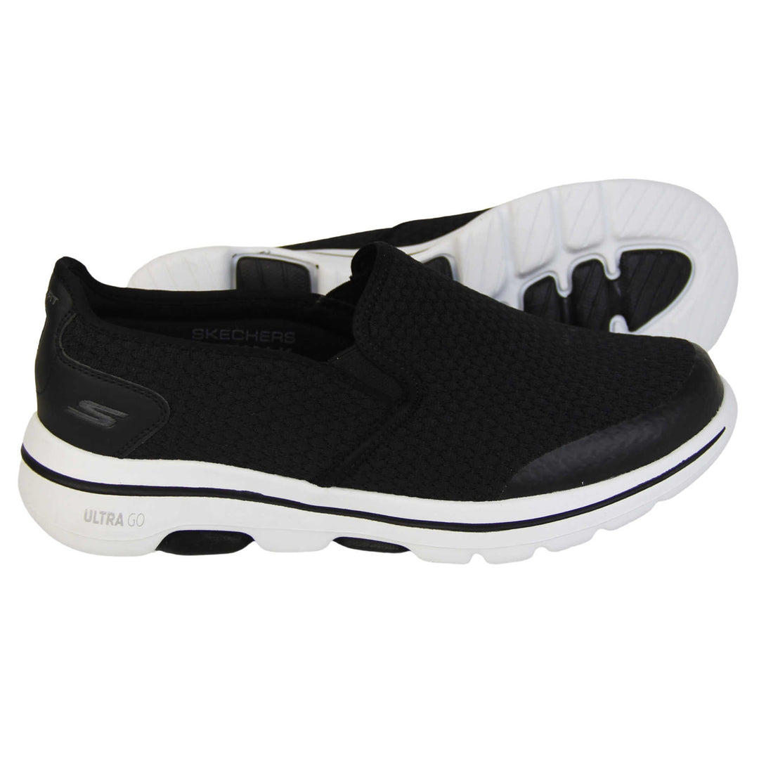 Mens wide fit skechers. Mens loafer style trainers. Black woven mesh upper. Skechers S logo to the back. chunky white sole with a black ling running around the middle and grip to the bottom. Black textile lining. Both feet from a side profile with the left foot on its side to show the sole.