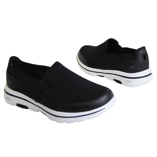 Mens wide fit skechers. Mens loafer style trainers. Black woven mesh upper. Skechers S logo to the back. chunky white sole with a black ling running around the middle and grip to the bottom. Black textile lining. Both feet from a slight angle facing top to tail.