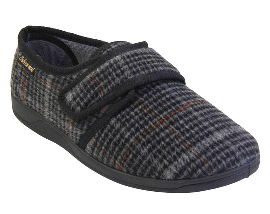 Mens adjustable slippers. Full back slippers with a black and grey check upper and black edging around the strap and collar of the shoe. Touch fasten strap across the bridge of the foot. Chunky black synthetic sole. Right foot at an angle.