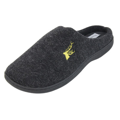 Mens backless slippers. Mule style slippers with black fleece uppers with an embroidered stag head to the top, on the outside. Black terry lining and firm black sole. Left foot at an angle.
