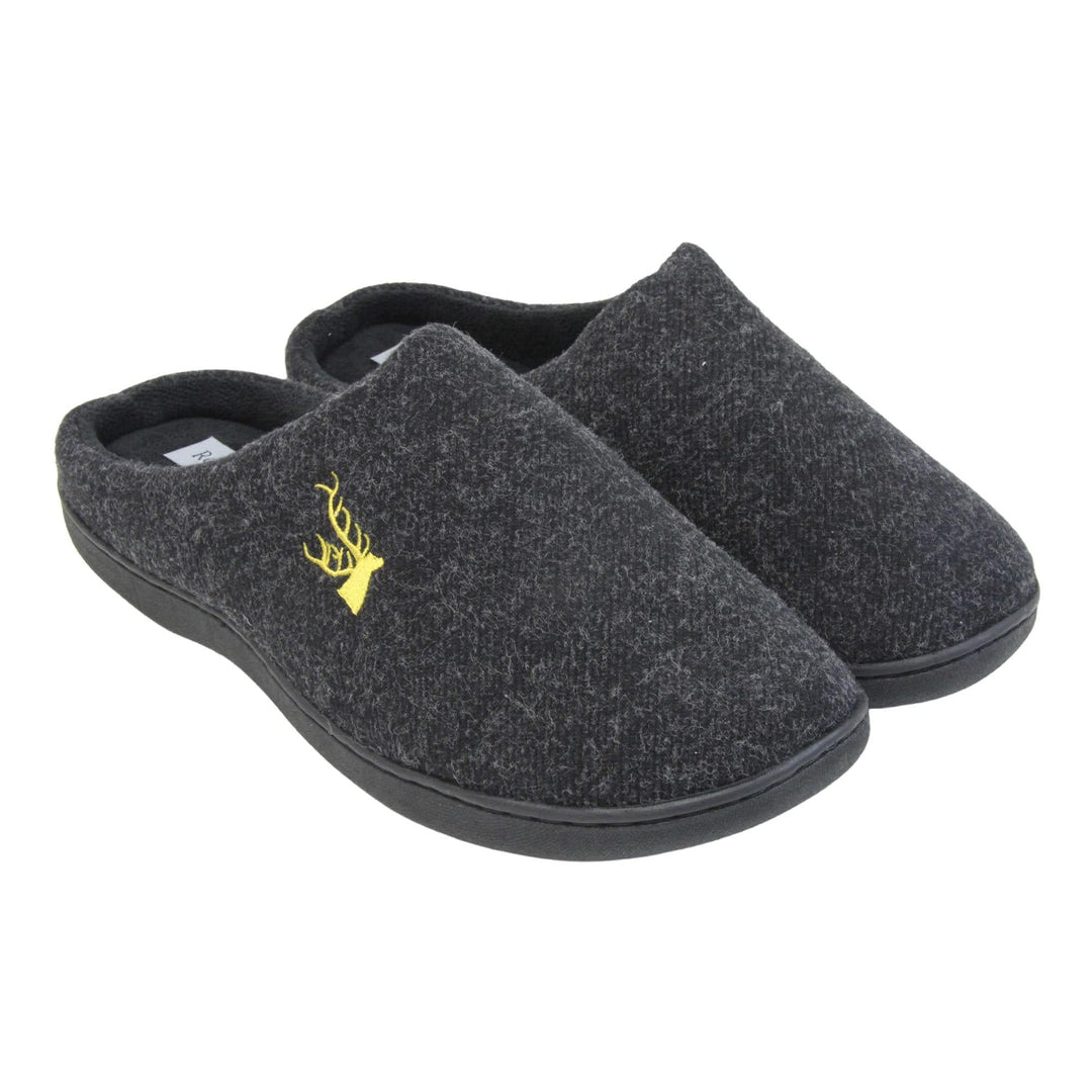 Mens backless slippers. Mule style slippers with black fleece uppers with an embroidered stag head to the top, on the outside. Black terry lining and firm black sole. Both feet together at an angle.