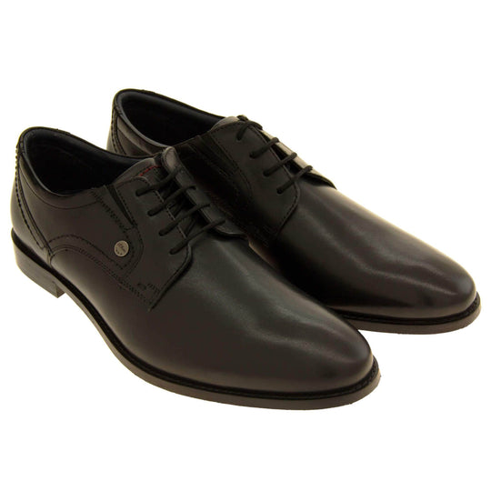 Mens black dress shoes. Mens formal shoes with a black leather upper and black stitching detail. Black laces to the front. Small silver stud on the side with S.Oliver written on. Black sole with very slight heel. Black lining. Both shoes together from an angle.