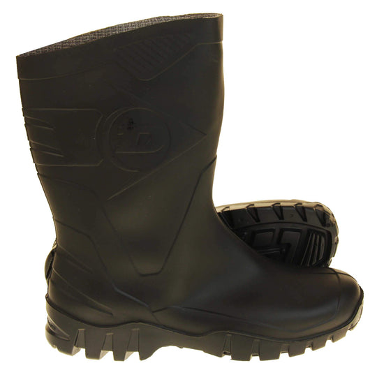 Mens Short Wellies. Black calf length wellies with a waterproof rubber upper and sole. With embossed pattern down the back of the boot and Dunlop logo on the side. Both feet from side profile with the left foot on its side to show the sole.