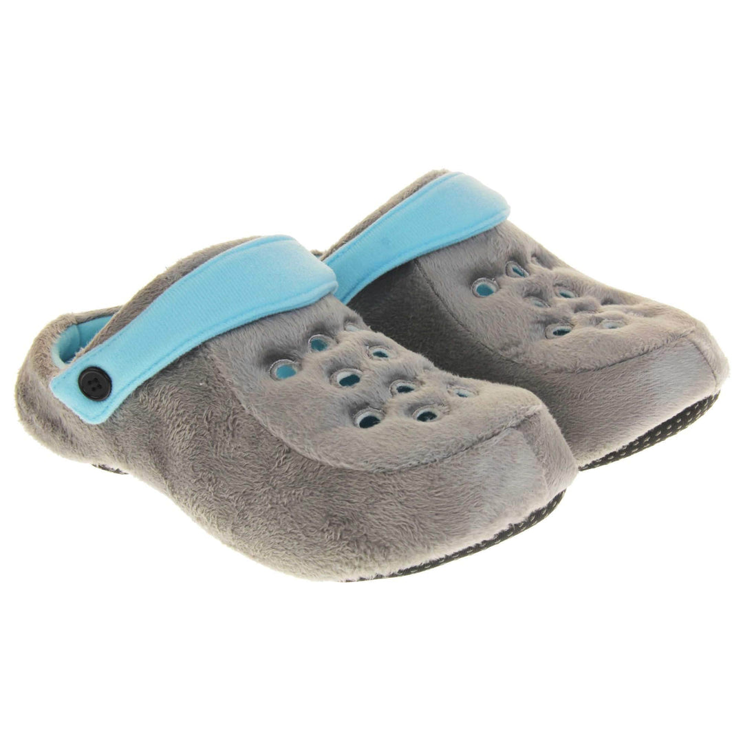 Mens clog slippers. Grey fabric clog style novelty slipper. Cut out holes on the upper. Light blue strap that goes along the back of your heel. The strap can be moved along the top of the shoe instead to make the shoe a mule. Both shoes next to each other at a slight angle.