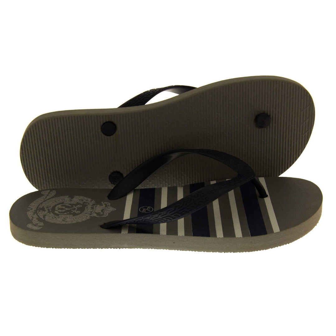 Mens flip flop sandals. Flip flop with dark grey striped sole and black strap in a toe-post design. Both feet from side profile with the left foot on its side behind the right to show its sole.