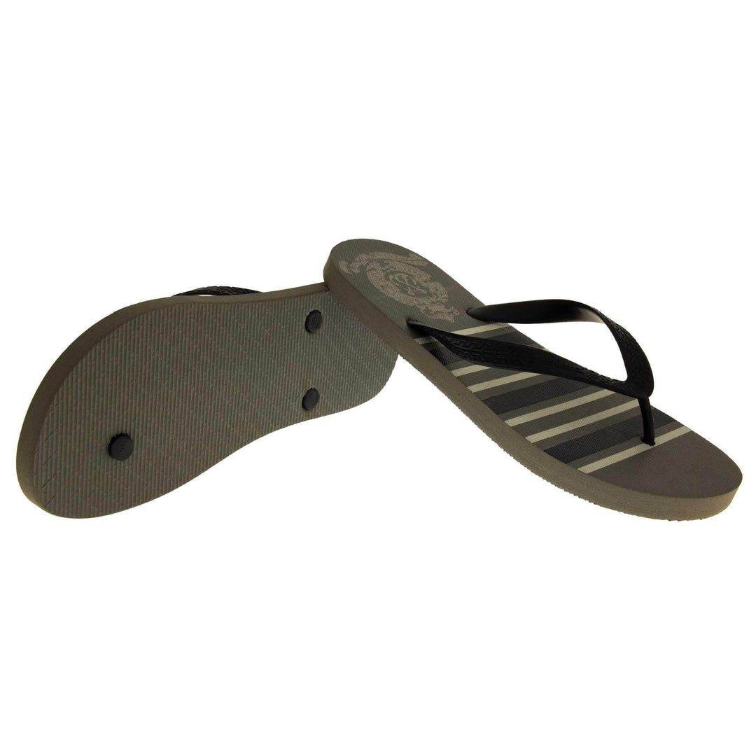 Mens flip flop sandals. Flip flop with dark grey striped sole and black strap in a toe-post design. Both shoes in a wide V shape with right foot on its side to show the sole and left foot leaning its heel on top to lift it at the back.