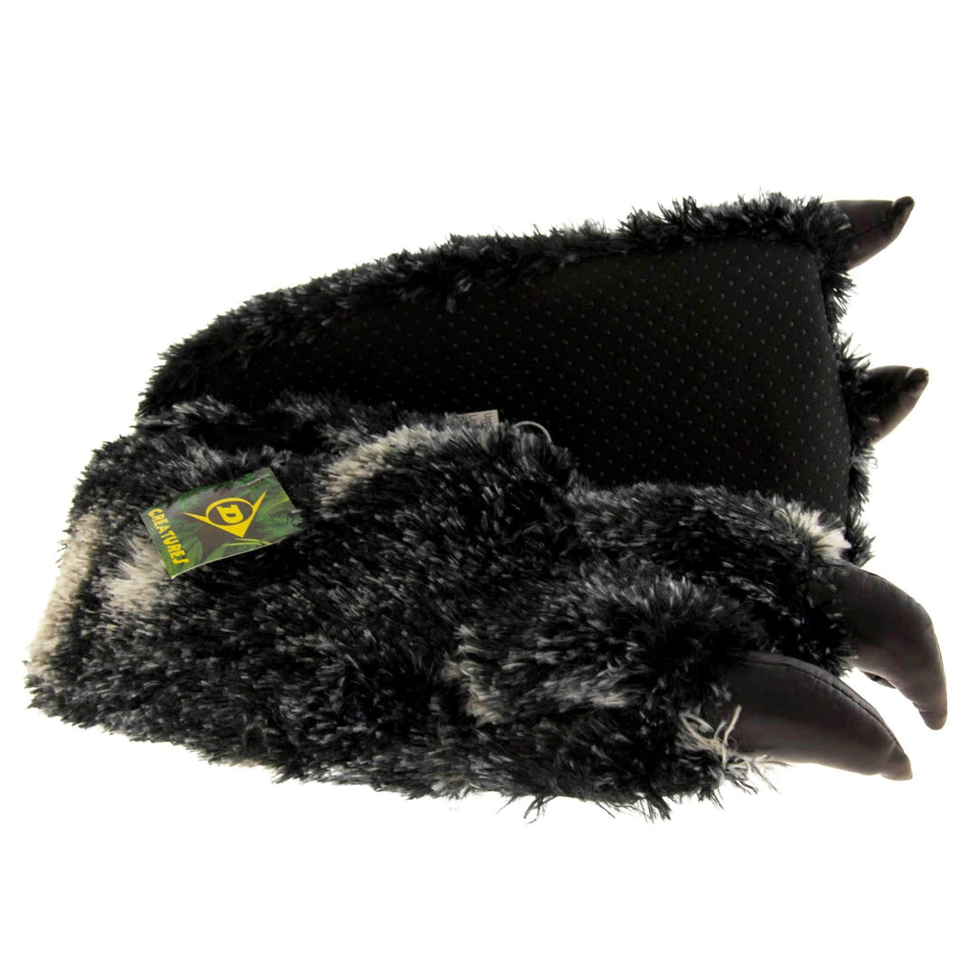 Mens fluffy slippers. Cushioned slippers shaped like a monster's foot with claws . Black and grey faux fur outer and black shiny padded claws. Inside is a textile lining. Black soft sole with bumps on for grip. Both feet from side profile with left foot on its side to show the sole.