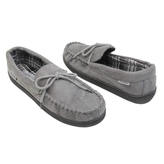Mens grey moccasin slippers. Moccasin style slipper with grey faux suede upper and rope style bow to the top. Grey Rosebank label to the outside. Dark and light grey and white plaid textile lining. Black rubber sole. Both shoes spaced apart, facing top to tail at an angle.