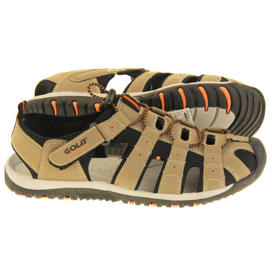 Mens hiking sandals. Traditional style sandal with brown and black fabric strappy upper. Black rubber toe caps and black synthetic sole with orange grips to the bottom. Elasticated laces to the front of the shoe and touch fasten strap by the ankle. Both feet from side profile with the left foot on its side behind the right to show its sole.