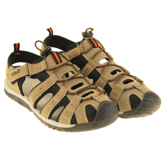 Mens hiking sandals. Traditional style sandal with brown and black fabric strappy upper. Black rubber toe caps and black synthetic sole with orange grips to the bottom. Elasticated laces to the front of the shoe and touch fasten strap by the ankle. Both feet together from a slight angle.