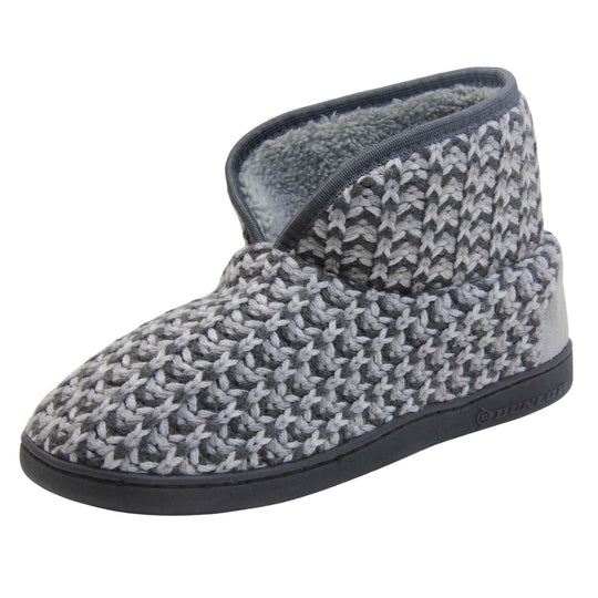 Mens knit slipper boots. Slipper boots with a grey knit upper. Dark grey fabric piping around the collar. Grey textile patch over the heel to reinforce. Thick black synthetic sole with Dunlop branding on. Grey faux fur lining. Left foot at an angle.
