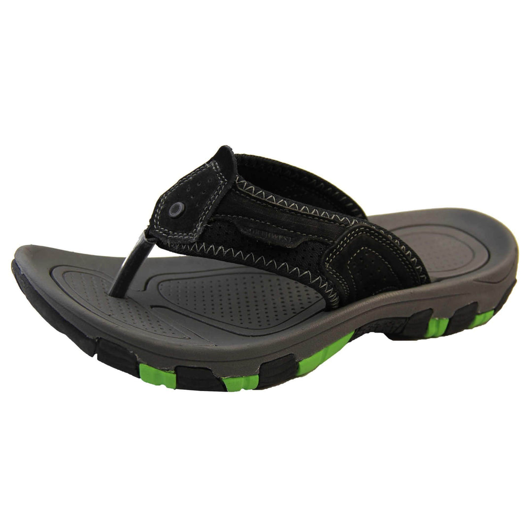 Mens leather flip flops. Black suede leather upper with white stitching detail. Black synthetic sole with green grip to the base. Left foot at an angle.
