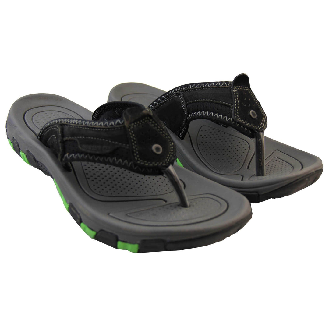 Mens leather flip flops. Black suede leather upper with white stitching detail. Black synthetic sole with green grip to the base.  Both feet together from a slight angle.