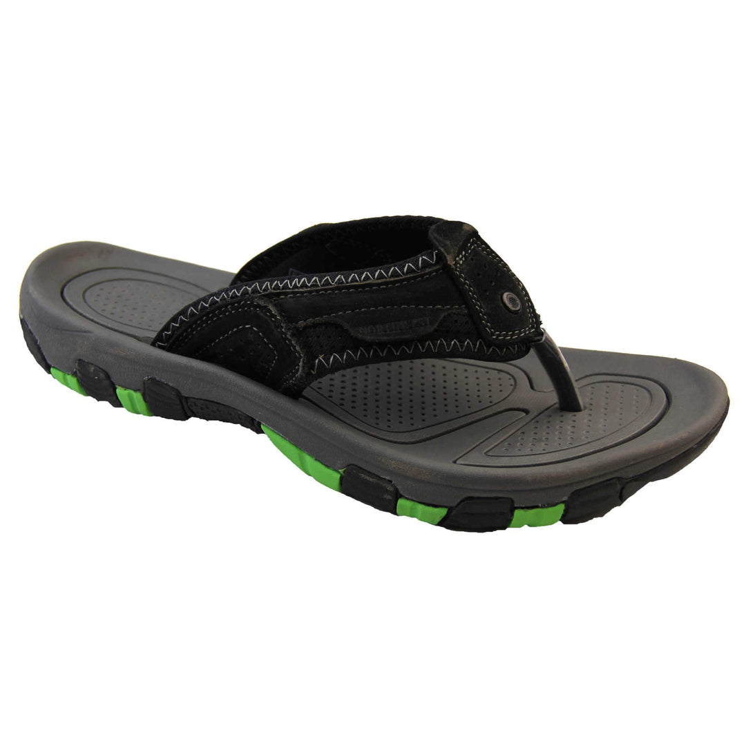 Mens leather flip flops. Black suede leather upper with white stitching detail. Black synthetic sole with green grip to the base. Right foot at an angle.