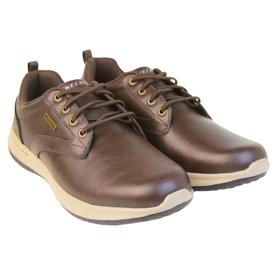 Mens leather skechers. Brown leather upper in trainer style shoe with brown stitching detail. Brown laces with gold eyelets for laces. White Skechers branding on tongue. Small gold rectangle tag to the side saying waterproof. Small S logo to the side of the heel. White outsole with black base. Brown textile lining. Both shoes together at an angle.