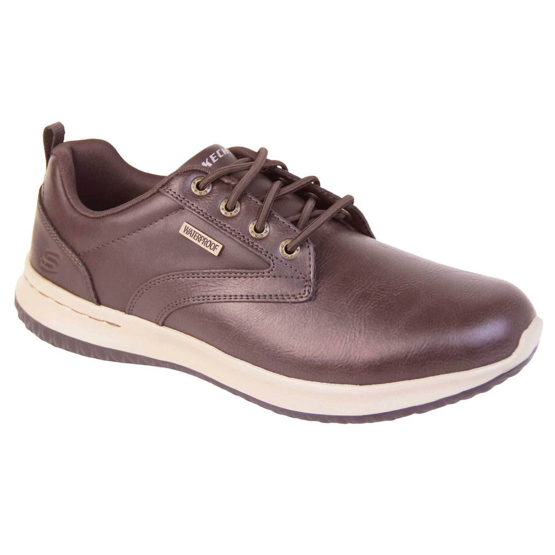 Mens leather skechers. Brown leather upper in trainer style shoe with brown stitching detail. Brown laces with gold eyelets for laces. White Skechers branding on tongue. Small gold rectangle tag to the side saying waterproof. Small S logo to the side of the heel. White outsole with black base. Brown textile lining. Right foot at an angle.