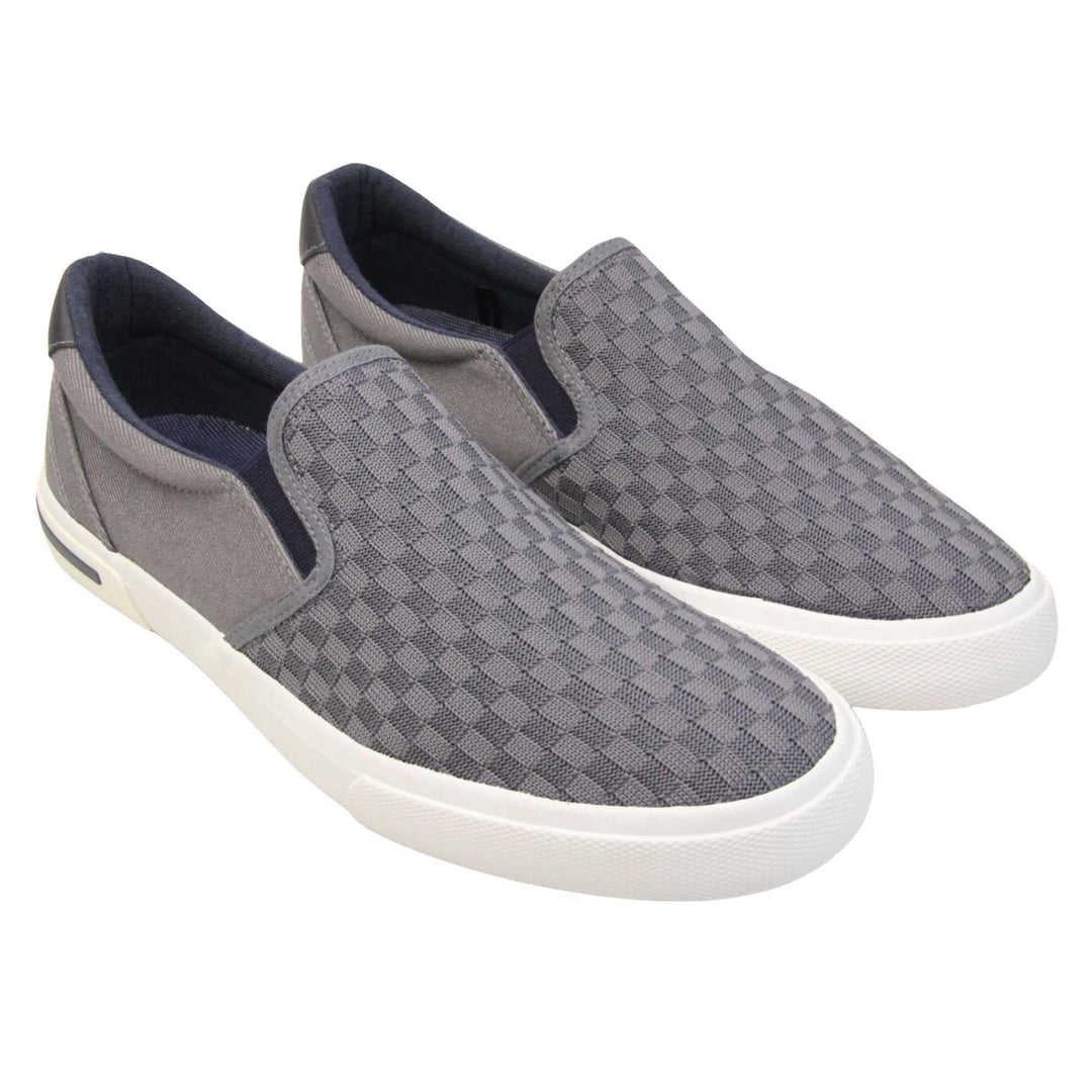 Mens lightweight trainers. Grey loafer style trainers with the upper made up of woven mesh for the front half and denim effect textile for the back. With a black faux-leather half circle to the heel with Oakenwood logo on. Black elasticated side gussets and black textile lining. Thick white sole. Both feet together at an angle.